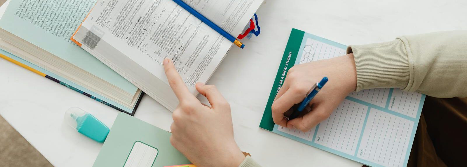 Person Studying And Writing Notes On Paper